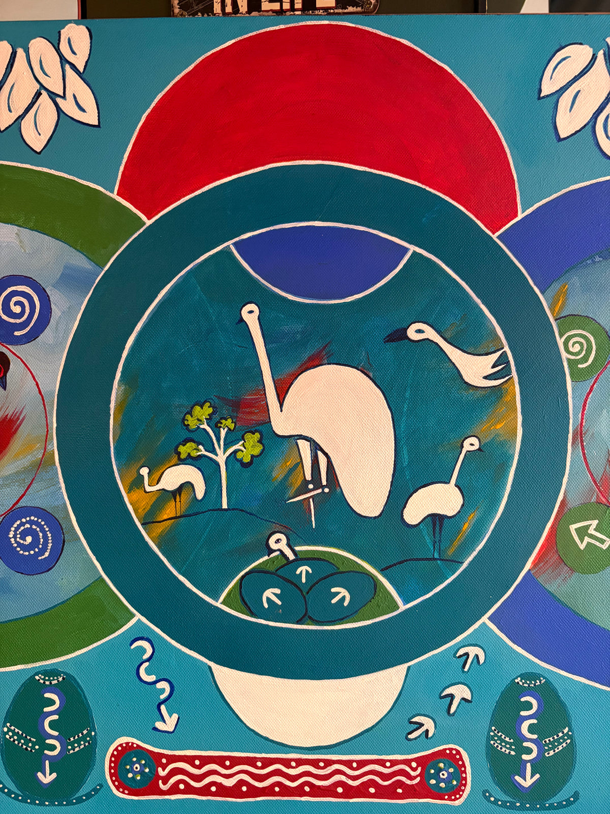 Central painting detail showing stylised white birds, a small tree and a red semicircle above.