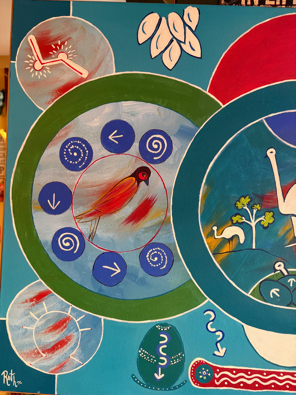 Left-side painting detail showing an orange bird surrounded by blue circles, arrows and spirals.