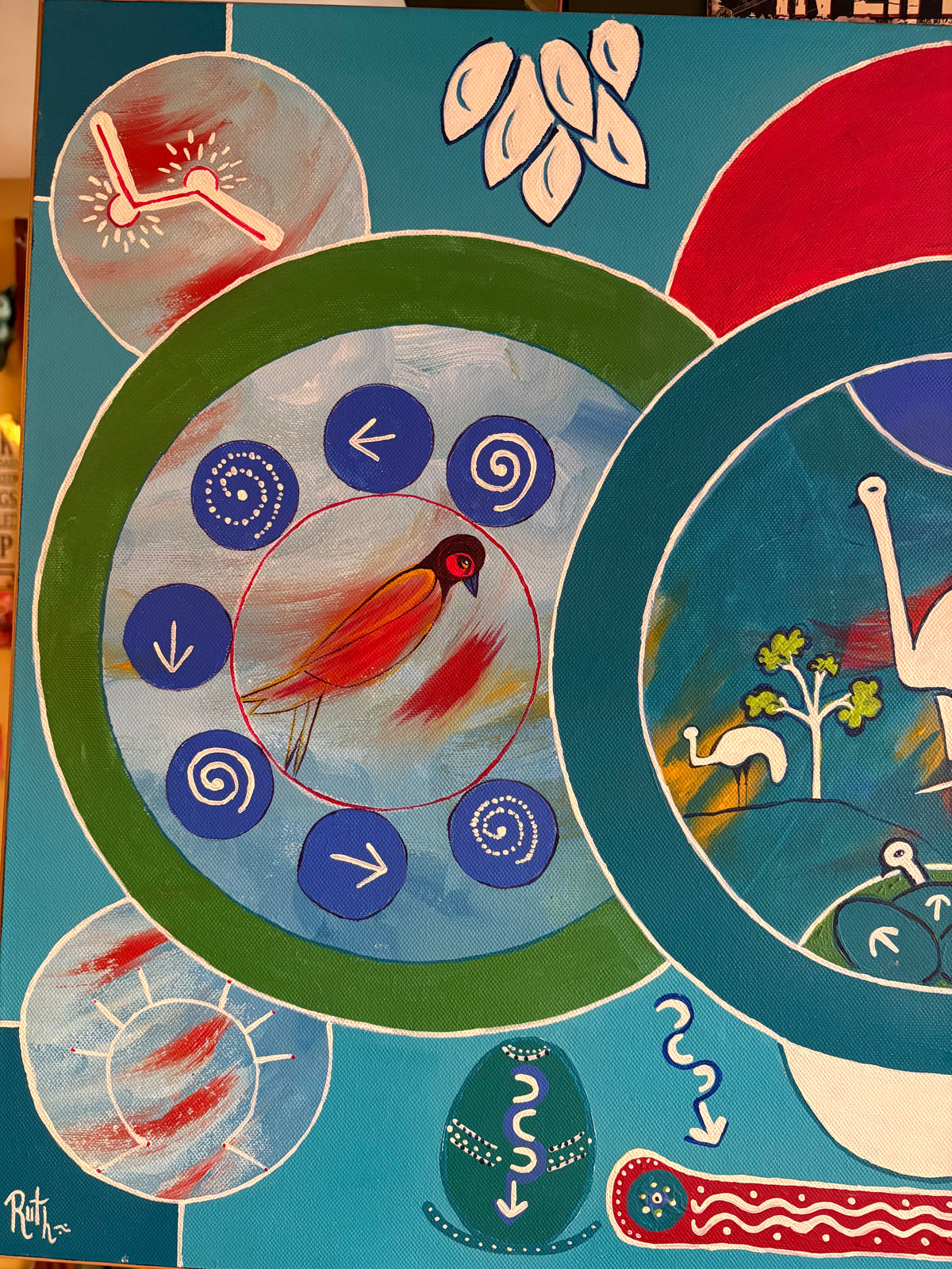 Left-side painting detail showing an orange bird surrounded by blue circles, arrows and spirals.
