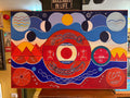 Colourful contemporary painting with patterned animal forms, sun and moon shapes, circles and blue waves.