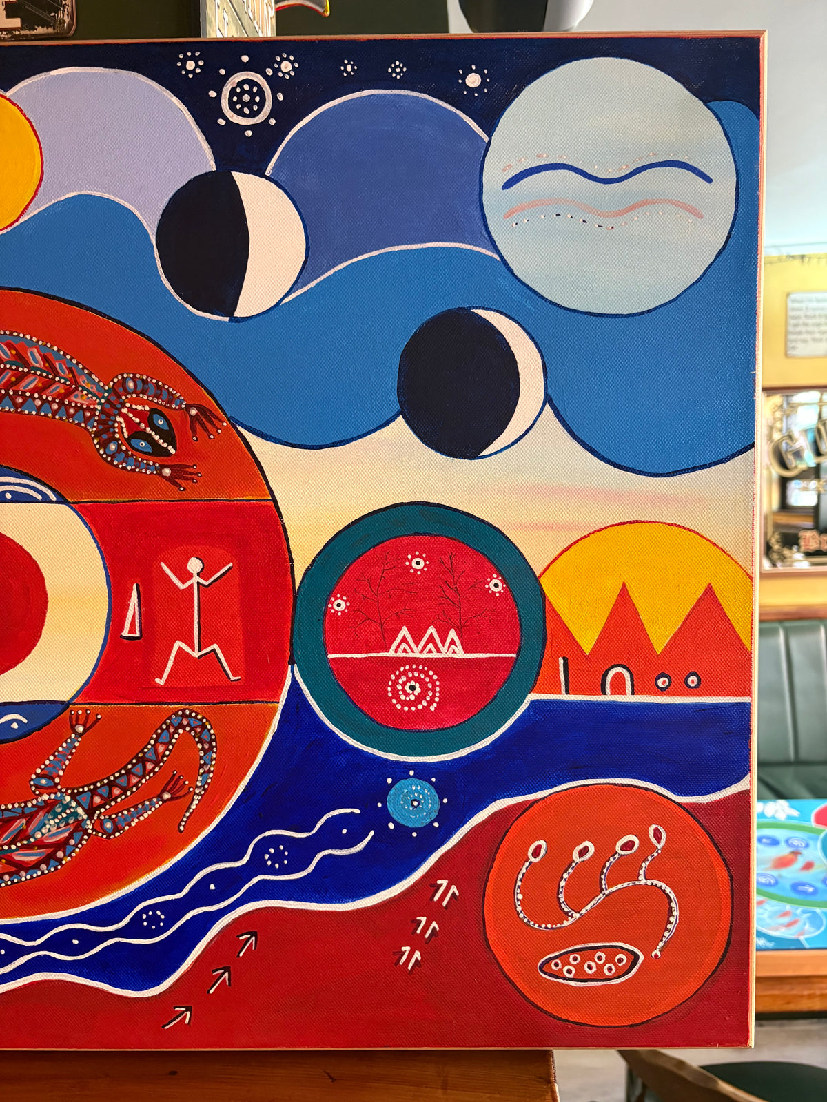 Right-side painting detail showing circular motifs, crescent moons and white lines across blue and red areas.