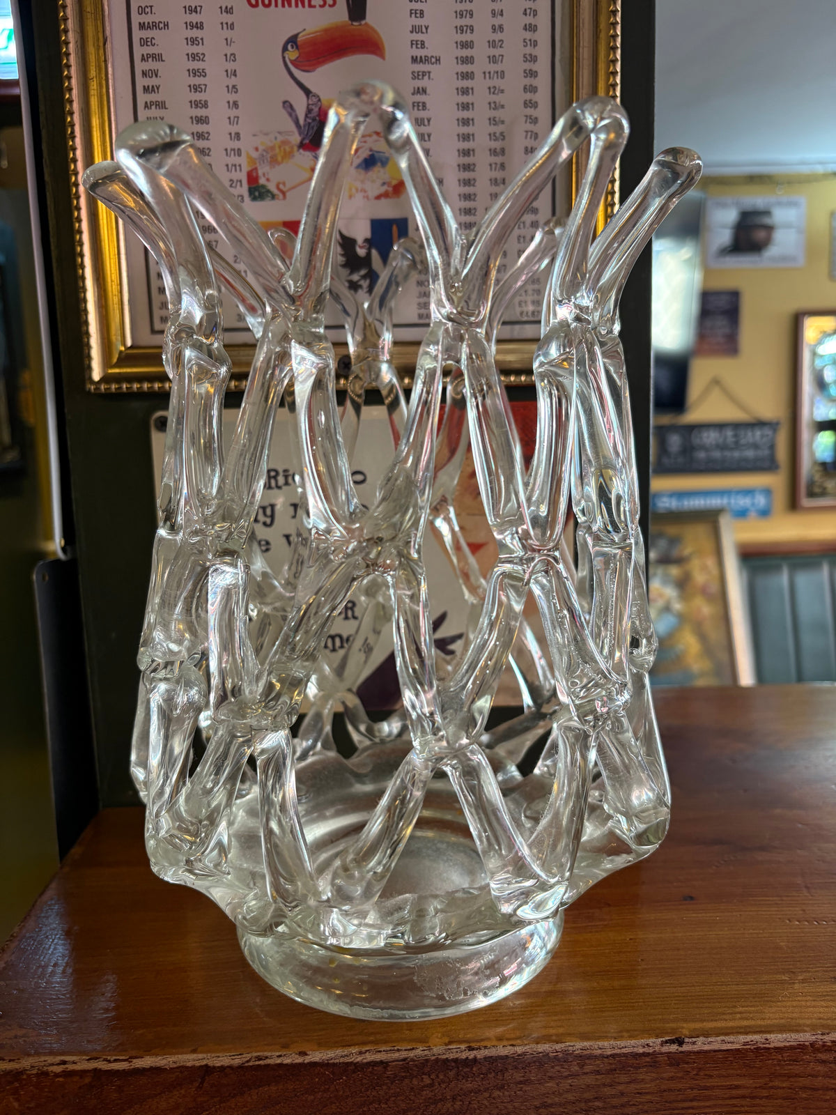 Front view of clear glass lattice vase showing elongated open loops and splayed rim