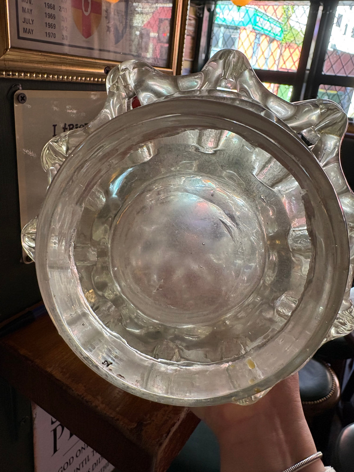 Underside of clear lattice glass vase showing its circular foot and base surface