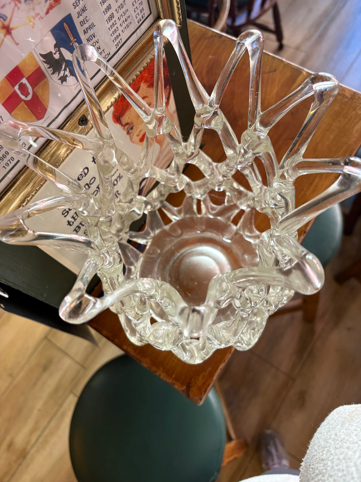 Overhead view of clear glass lattice vase showing its open looped rim and interior base