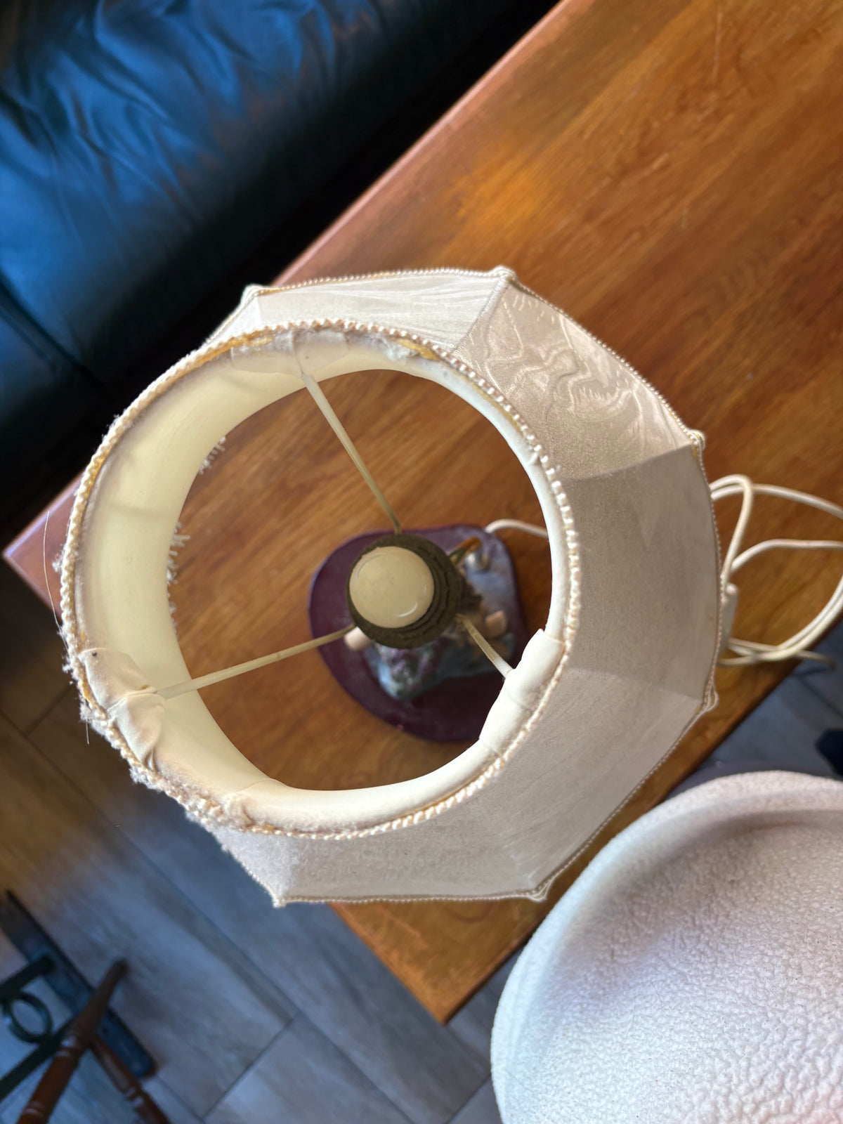 Top view into the cream lampshade showing its support frame and bulb holder