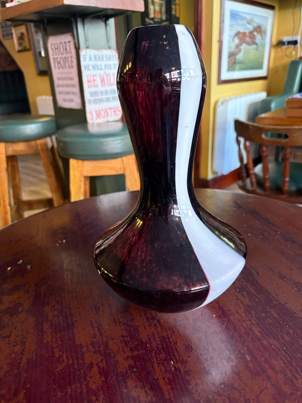 Dark purple glass vase with a broad white stripe, narrow waist and flared lower body