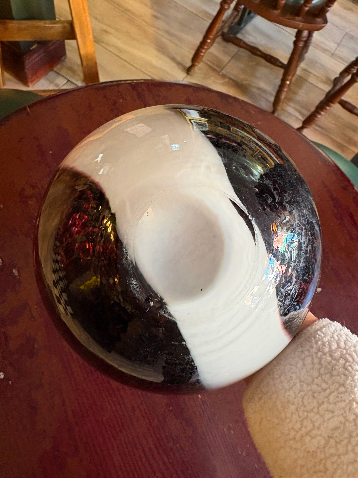 Underside of purple-and-white glass vase showing the circular base and surface marks