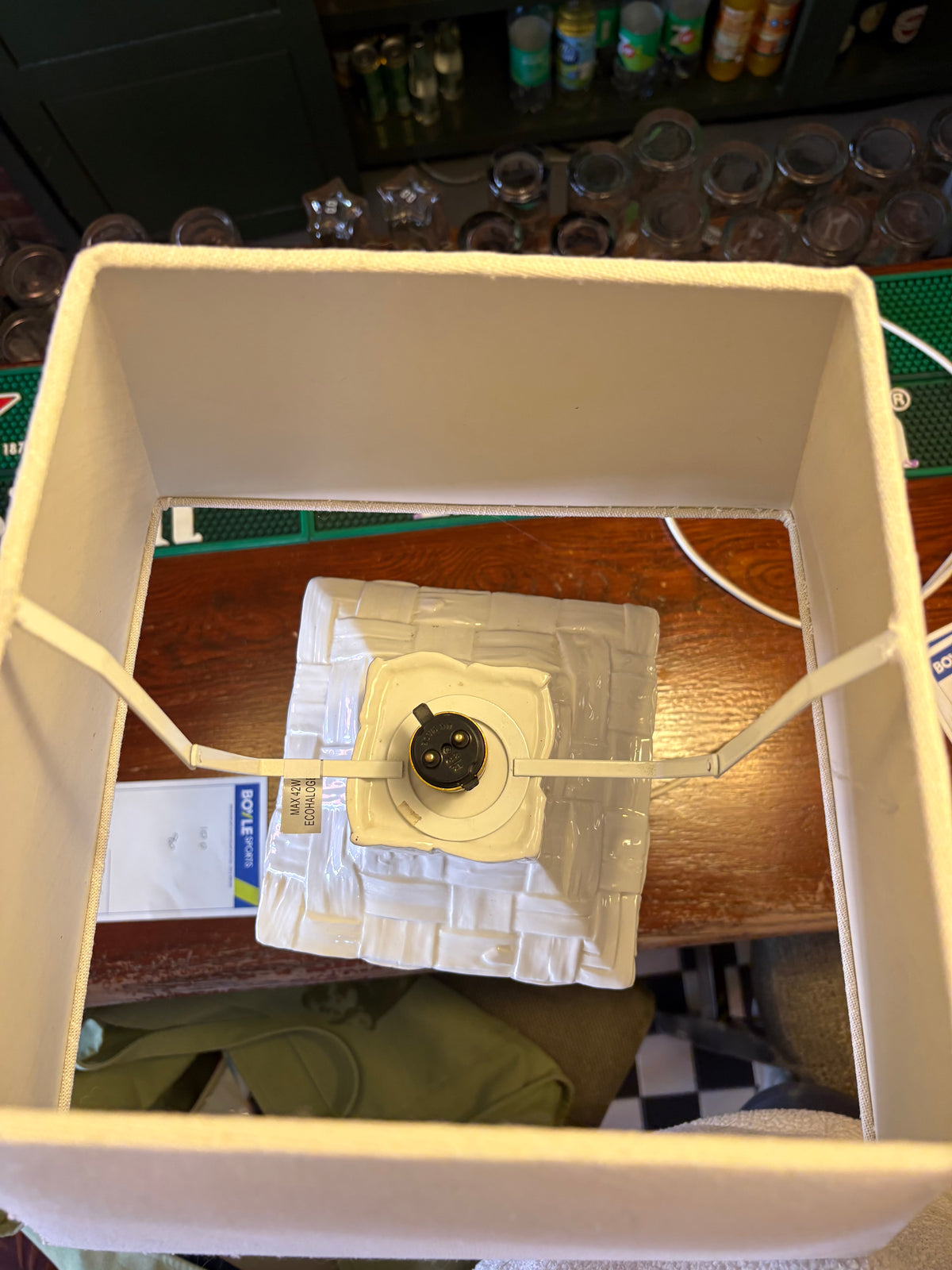 Overhead view inside the rectangular lampshade showing its frame and bulb holder