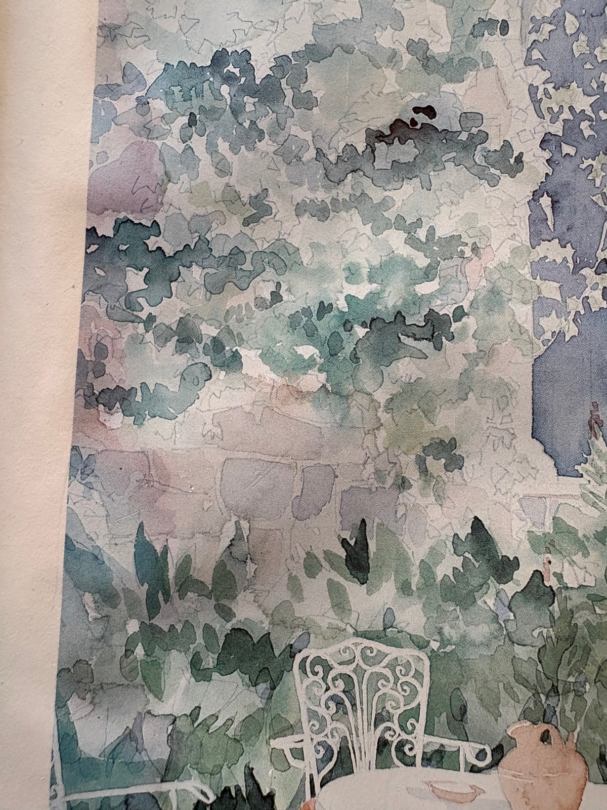 Left-side courtyard detail showing climbing foliage, stonework and an ornate white chair.