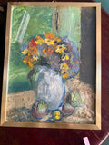 Framed textured still life of yellow, orange and purple flowers in a pale jug with fruit on a tabletop.