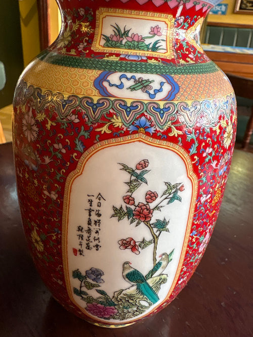 Close-up of porcelain vase panel with two birds, pink flowers and black calligraphy