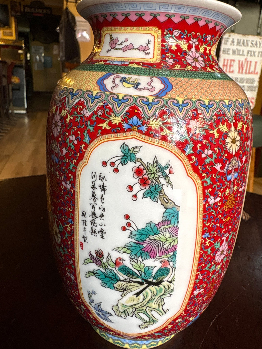 Another porcelain vase panel showing two birds among flowers and foliage on a red patterned ground