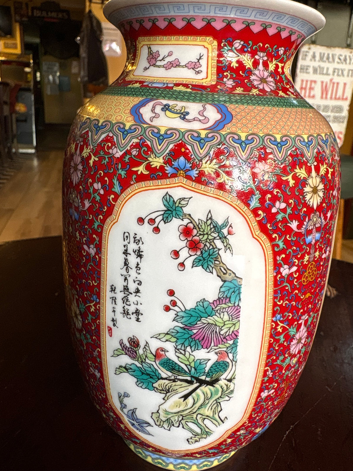 Another porcelain vase panel showing two birds among flowers and foliage on a red patterned ground