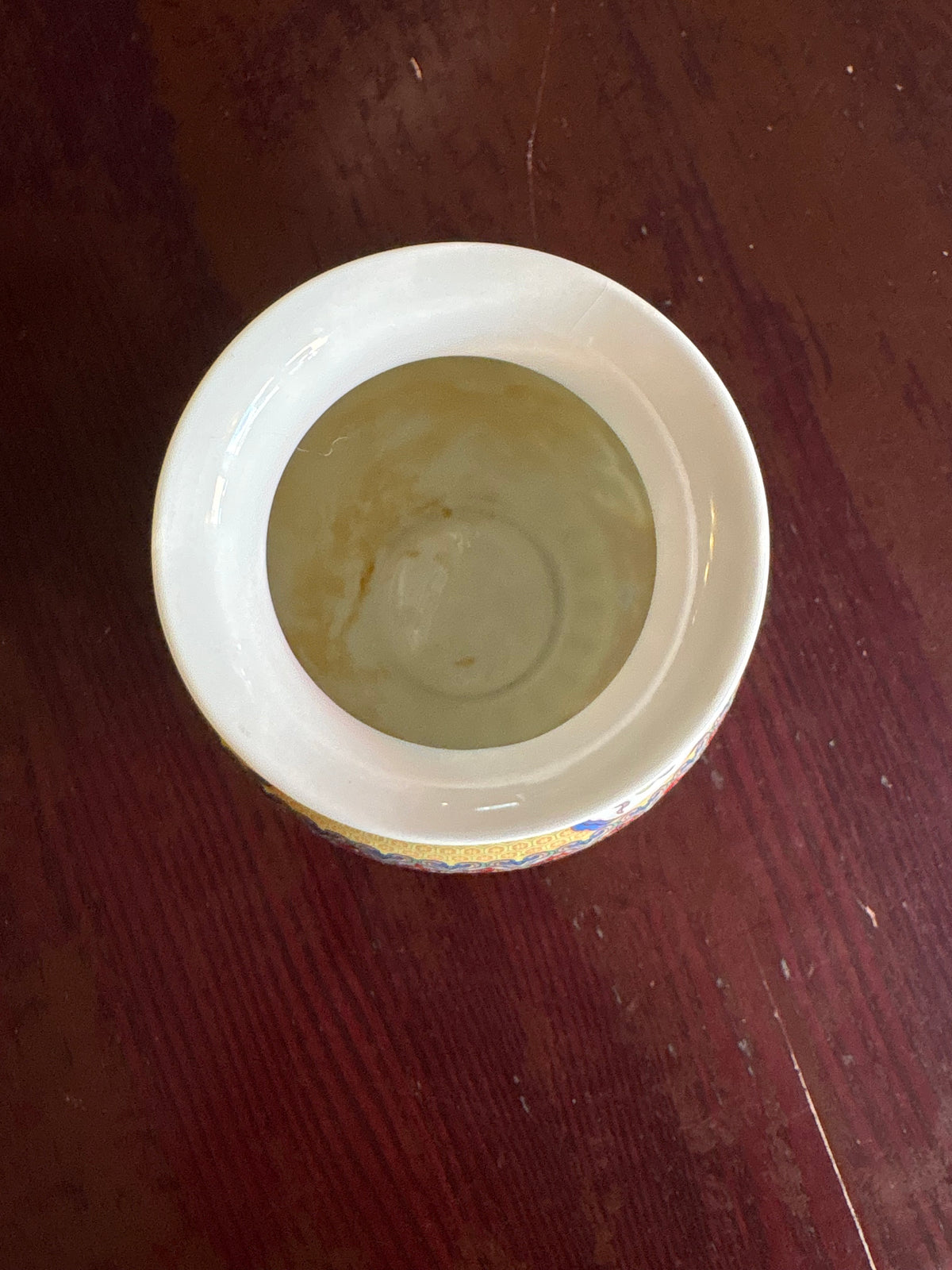 Overhead view into the porcelain vase showing its white rim and interior