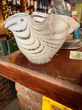 Clear handkerchief-shaped glass vase with sweeping white ribbon stripes and wavy rim