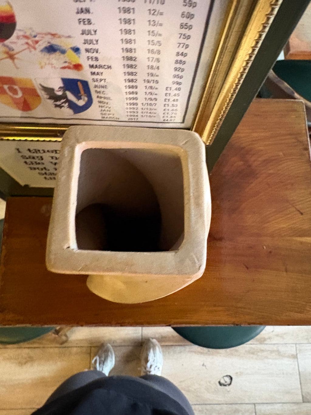 Top view of the square opening and interior of the cream twisted vase