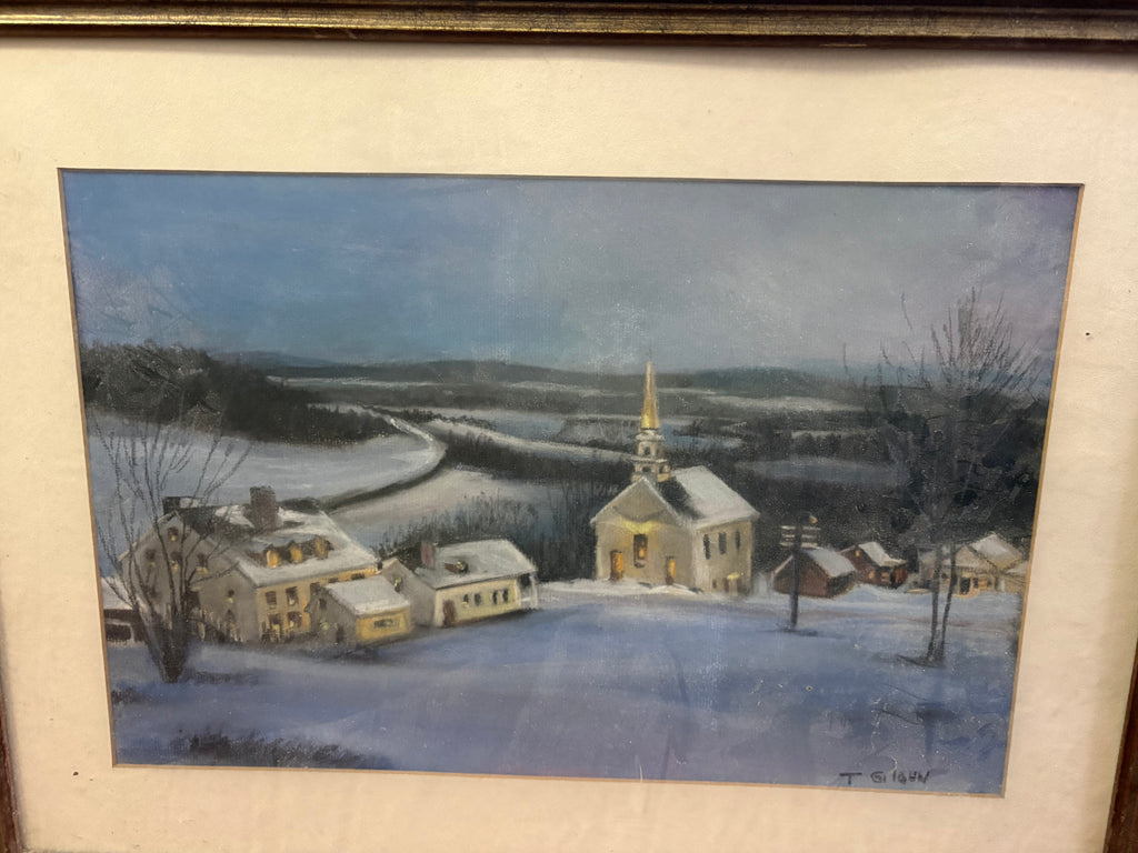 Framed winter village scene with a steepled church, snow-covered houses and fields beneath a blue sky.
