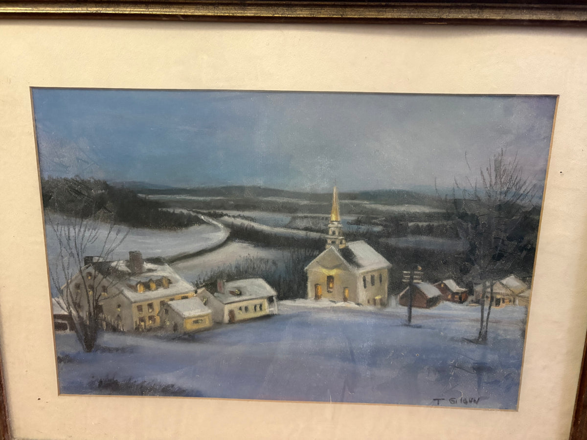 Framed winter village scene with a steepled church, snow-covered houses and fields beneath a blue sky.