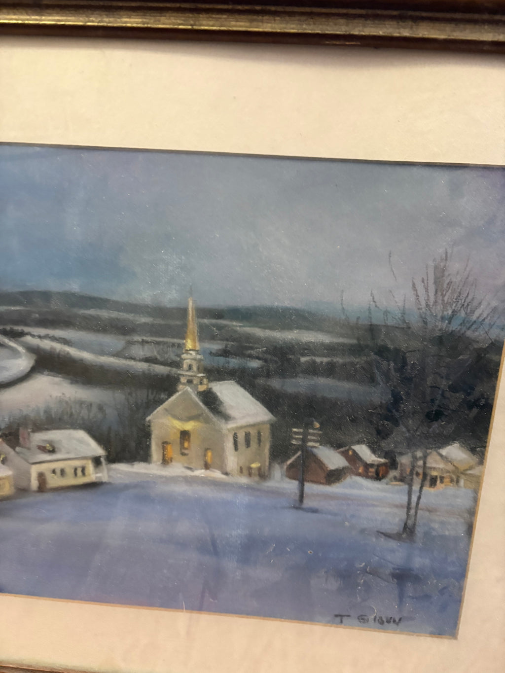 Winter village detail showing the church, bare trees, snowy roofs and lower-right signature.