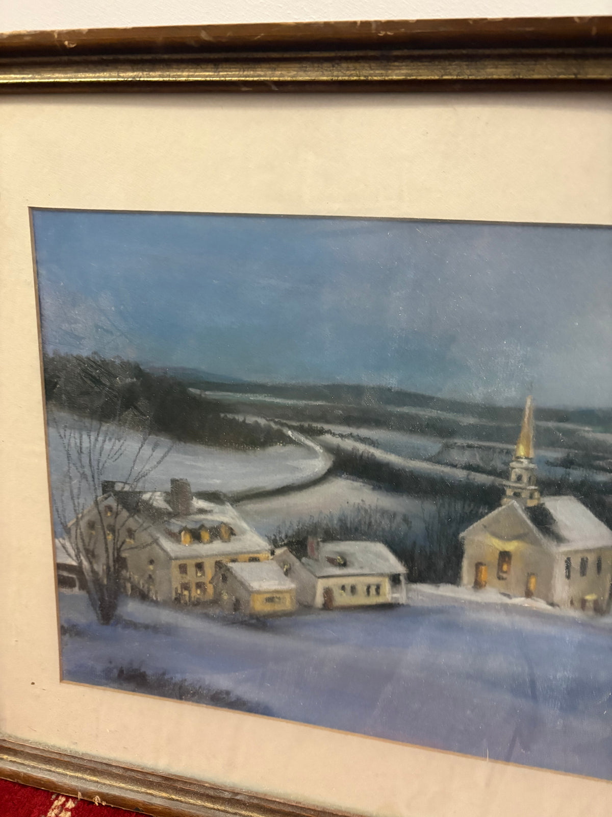 Left-side winter village detail showing snow-covered houses and a winding road across the fields.