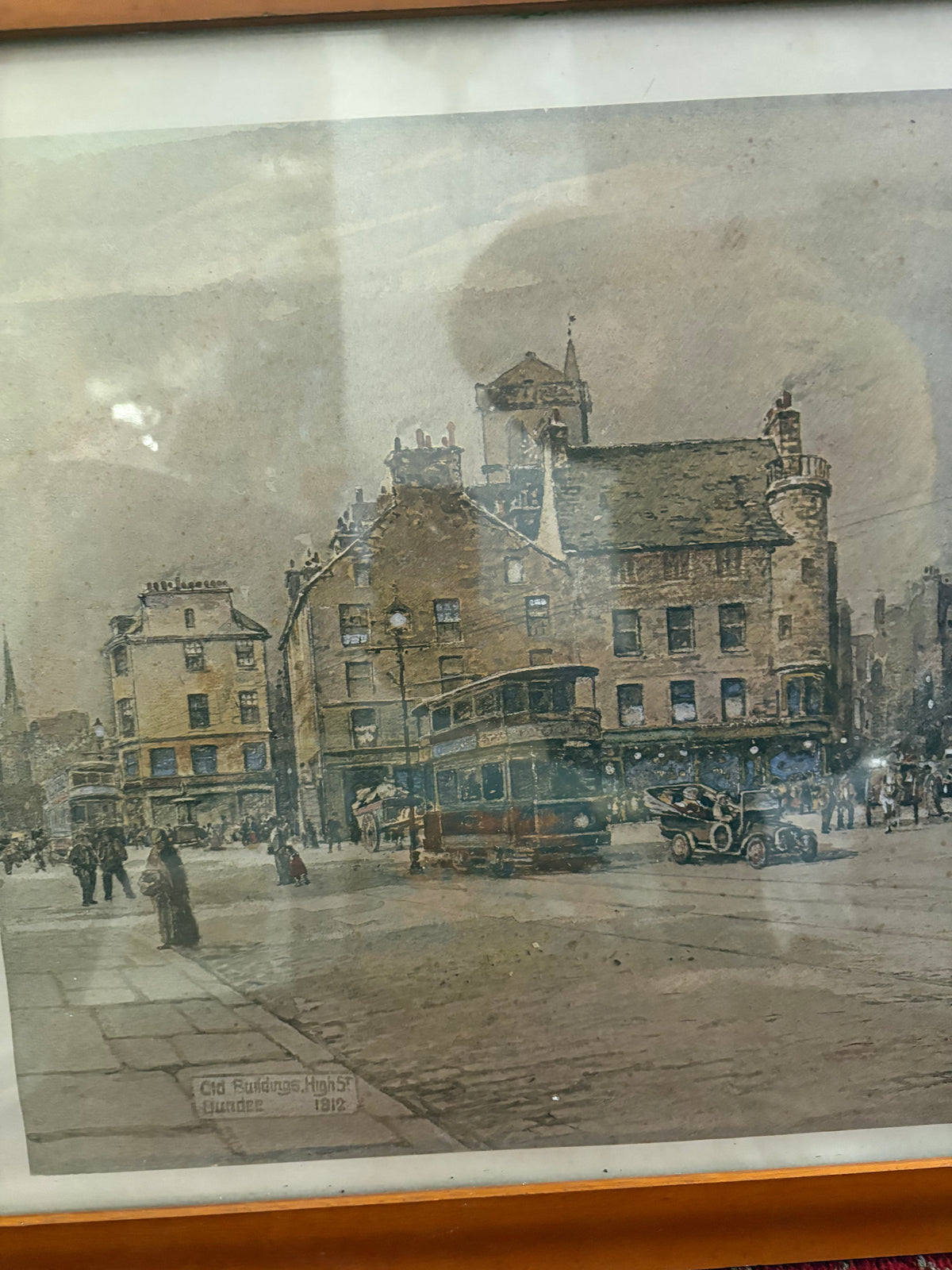 Detail of the Dundee street print showing a tram, early motor car and historic buildings.
