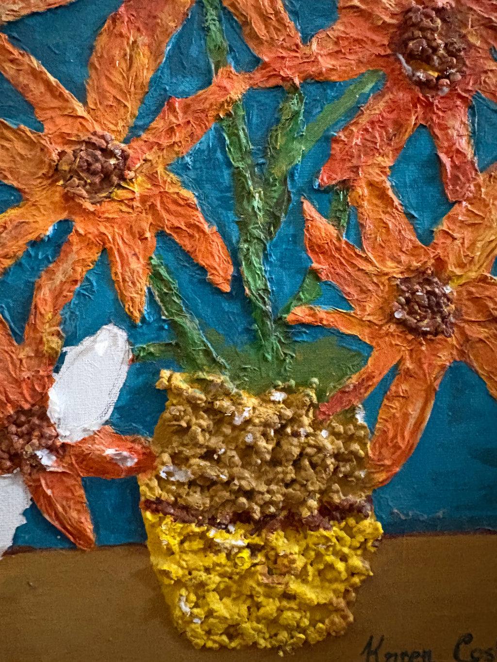 Close-up of raised paint texture on the yellow vase, green stems and orange flowers.