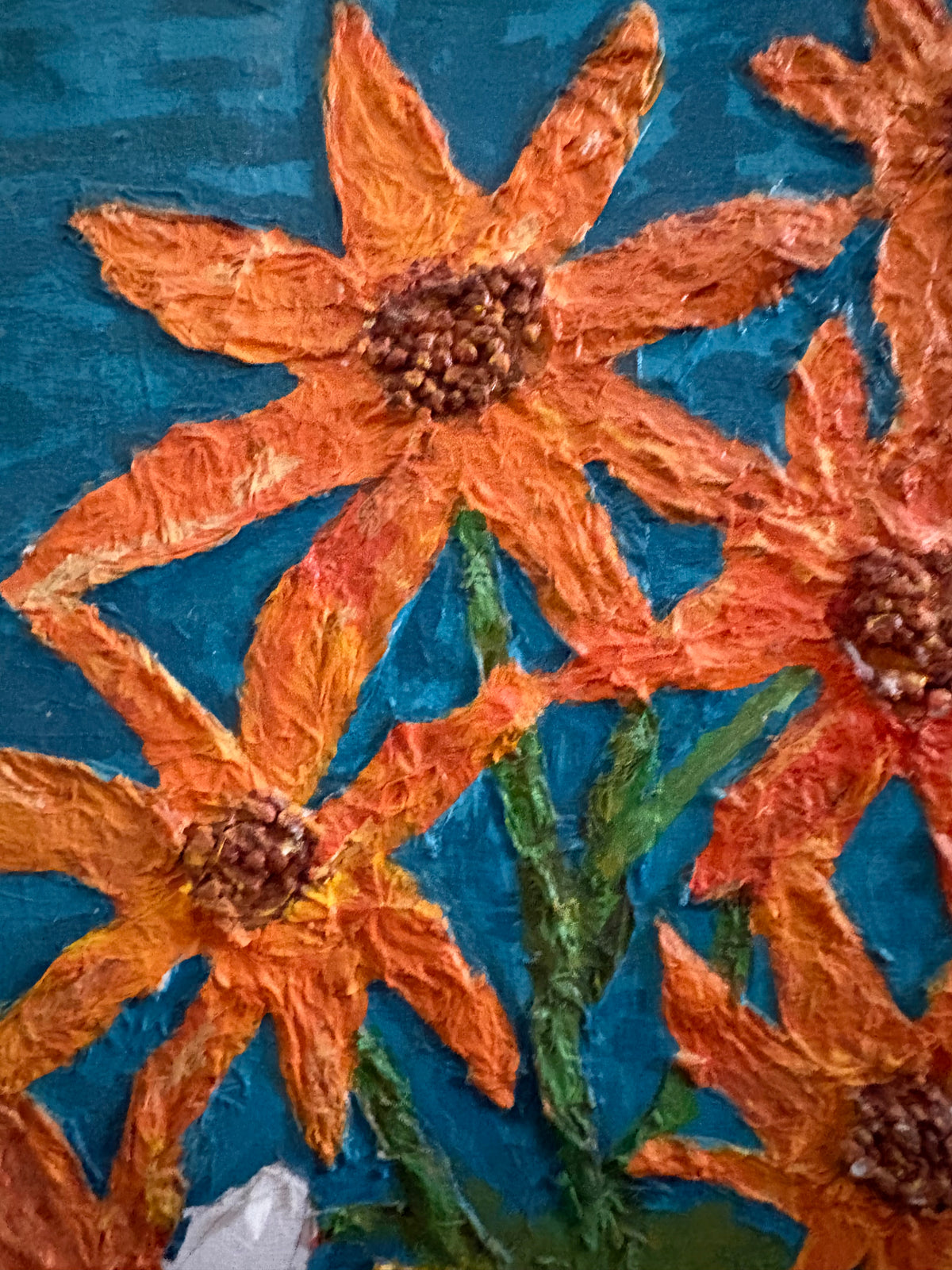 Detail of textured orange flowers, green leaves and stems in the floral painting.