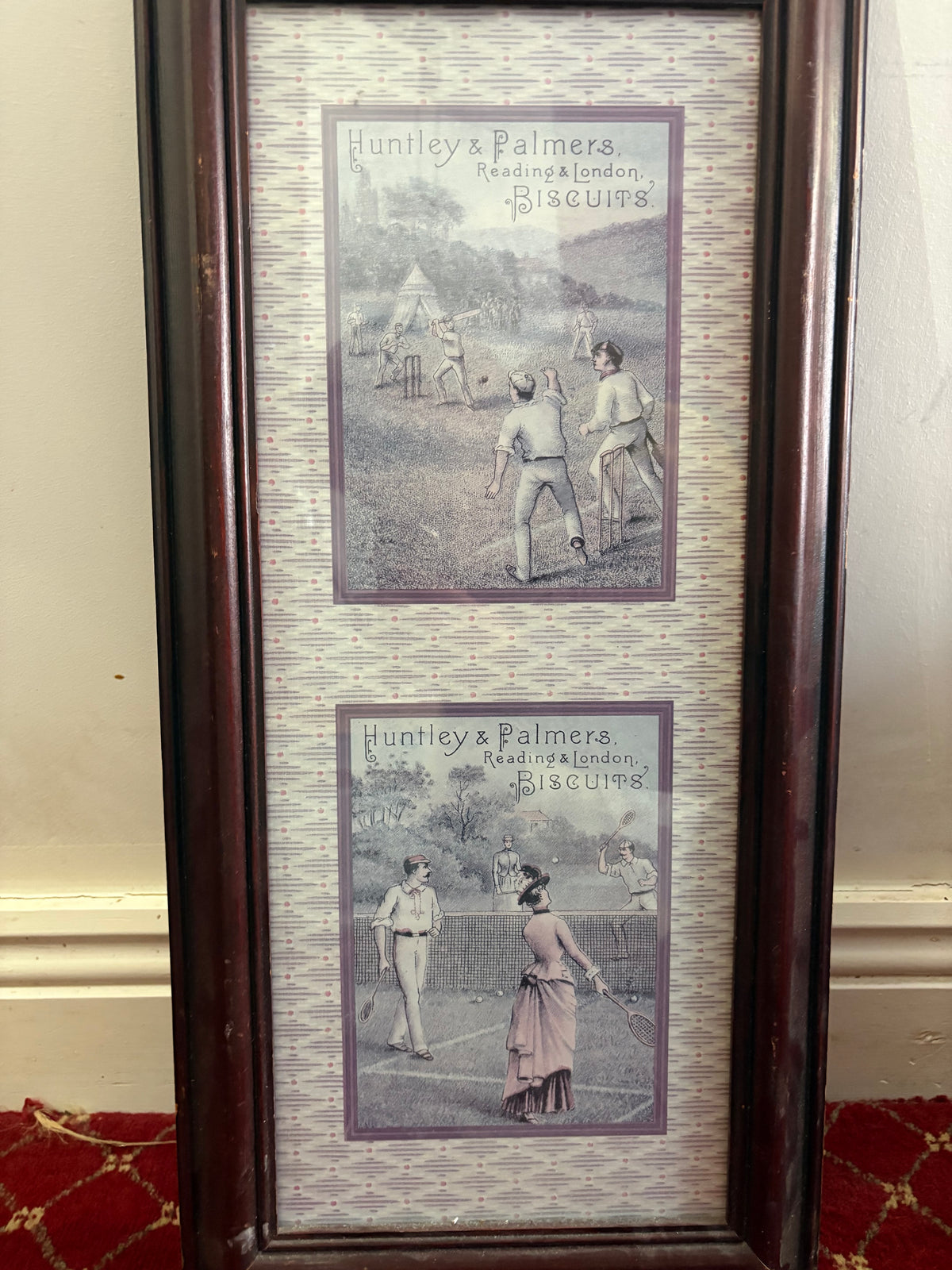 Two Huntley and Palmers biscuit advertising prints showing cricket and tennis in one tall wooden frame.