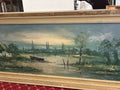Panoramic river landscape with a boat, cottage and distant church spires in a gold-toned frame.