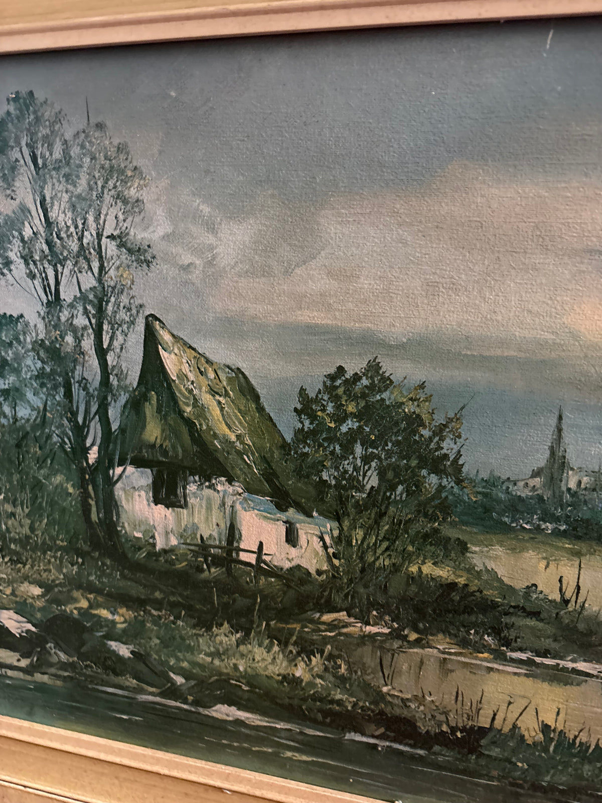 Left-side landscape detail showing a cottage, trees and the riverbank.