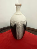 Cream-and-dark bottle-shaped vase with narrow neck and textured geometric panels