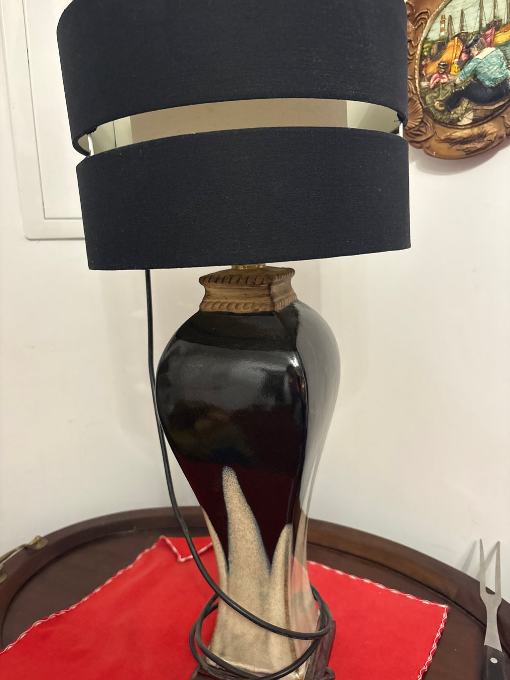 Two-tone ceramic table lamp with dark glaze, cream pointed motifs and black shade with a metallic band