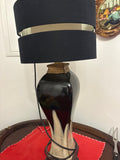 Two-tone ceramic table lamp with dark glaze, cream pointed motifs and black shade with a metallic band