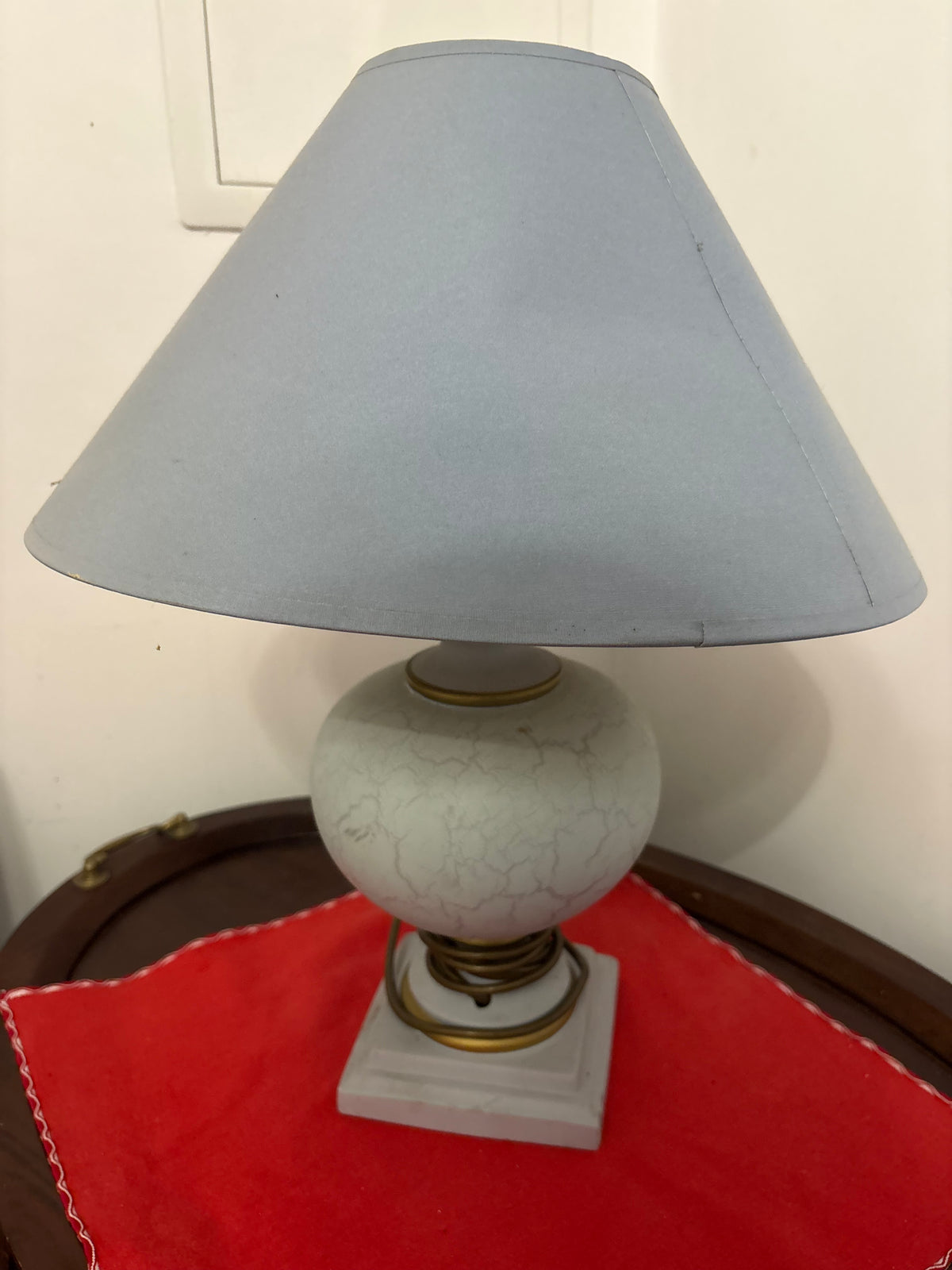 Pale ceramic table lamp with round crackle-glaze body, gold-coloured trim and light blue tapered shade