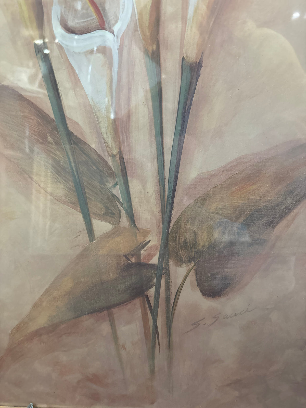 Lower floral detail showing long green stems, broad brown leaves and part of the white calla lilies.