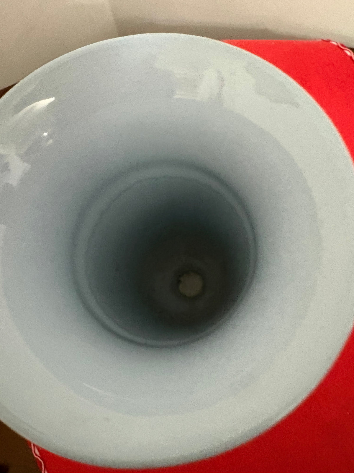 Overhead view into the blue-grey trumpet vase showing its broad rim and interior