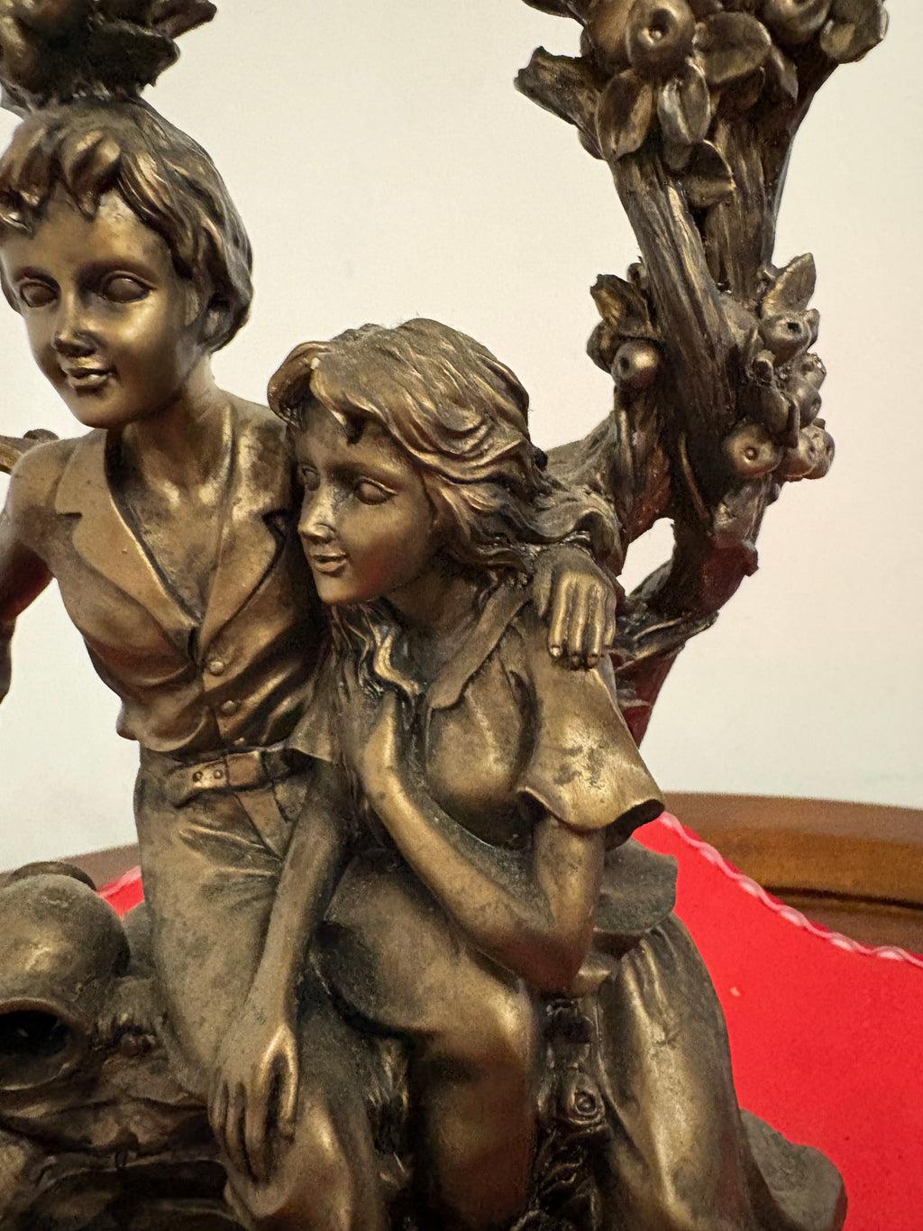 Angled close-up of the couple’s faces, the girl’s flowing hair and flowers on the arch