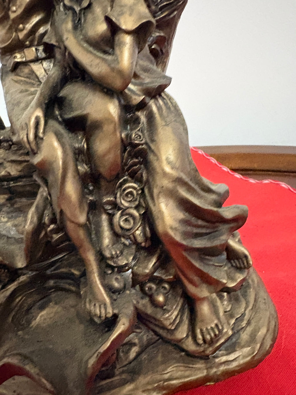Detail of the girl’s flowing skirt, bare feet and raised roses on the couple figurine base
