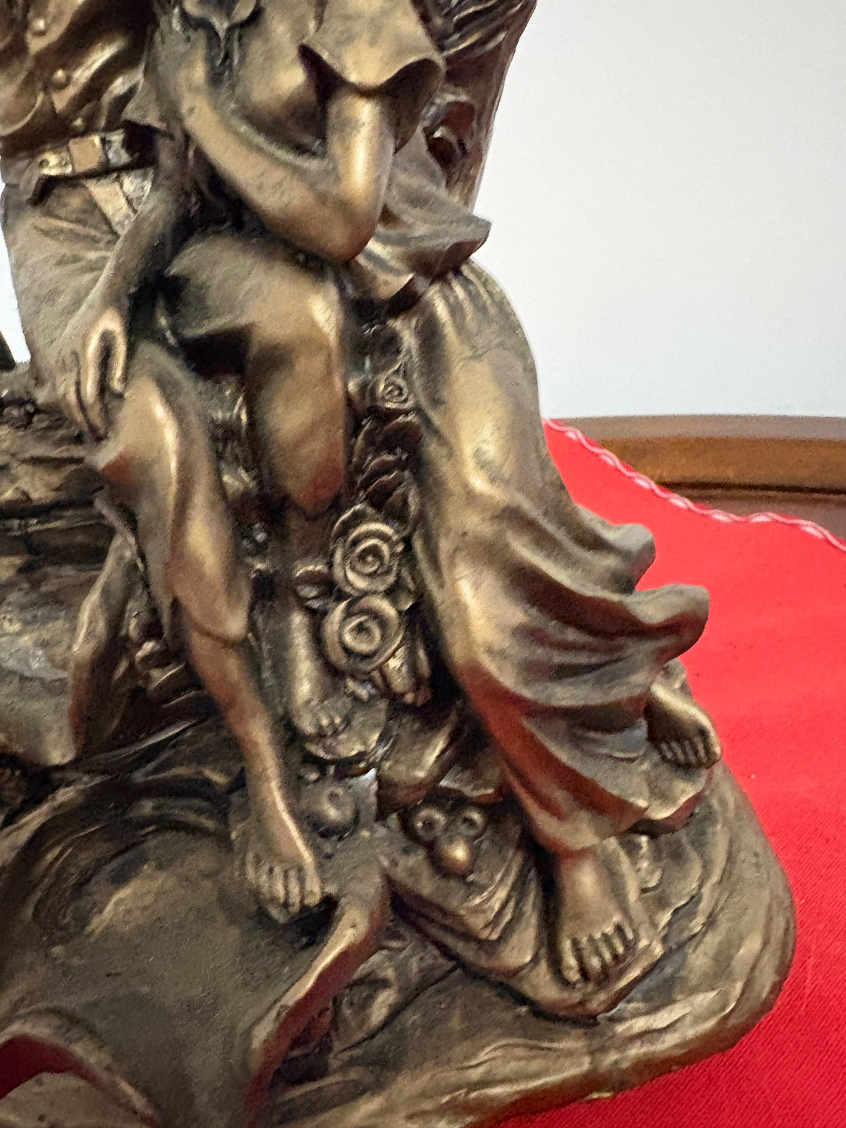 Detail of the girl’s flowing skirt, bare feet and raised roses on the couple figurine base