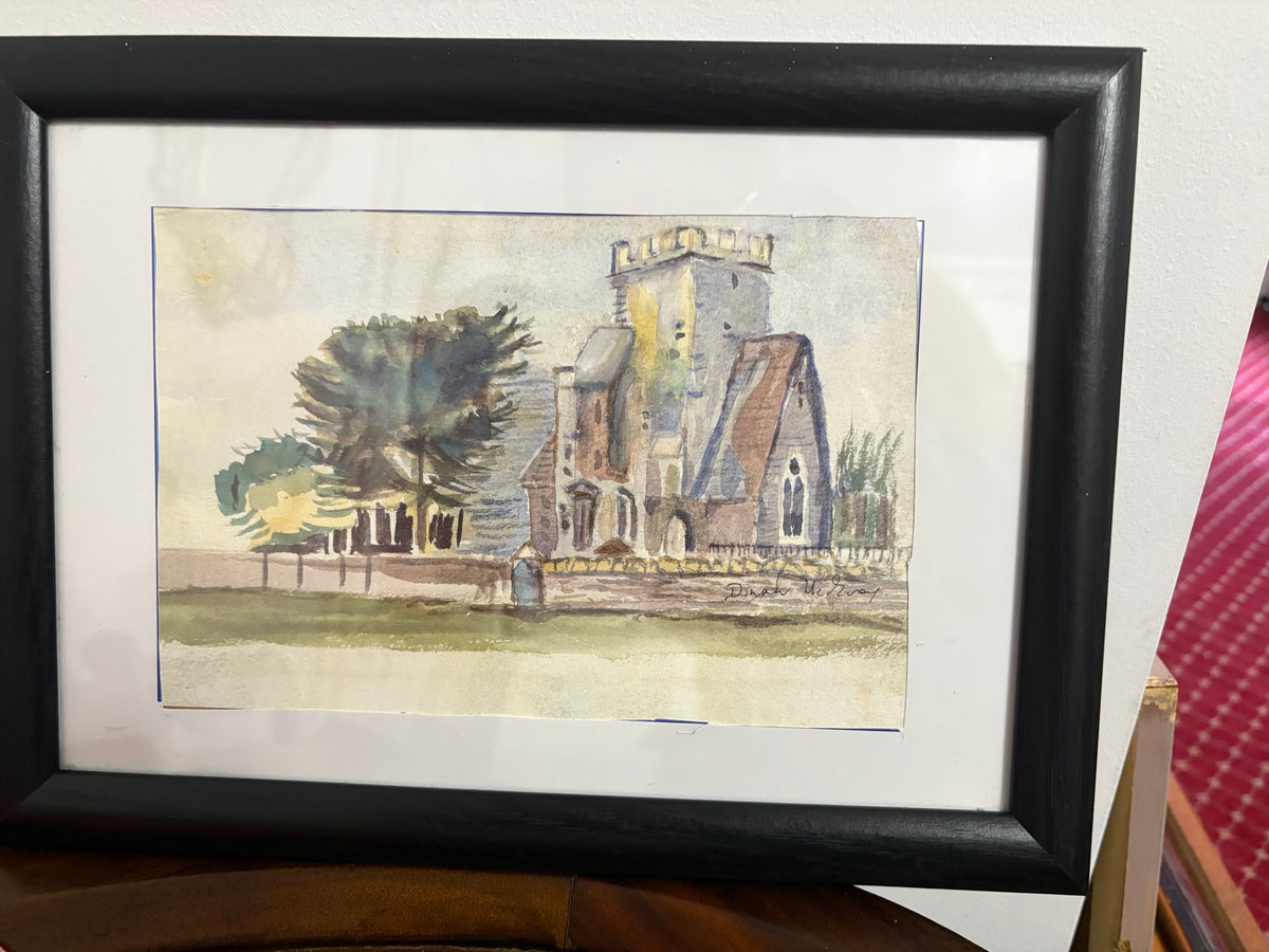 Framed church watercolour with a square stone tower, trees and cream mount.