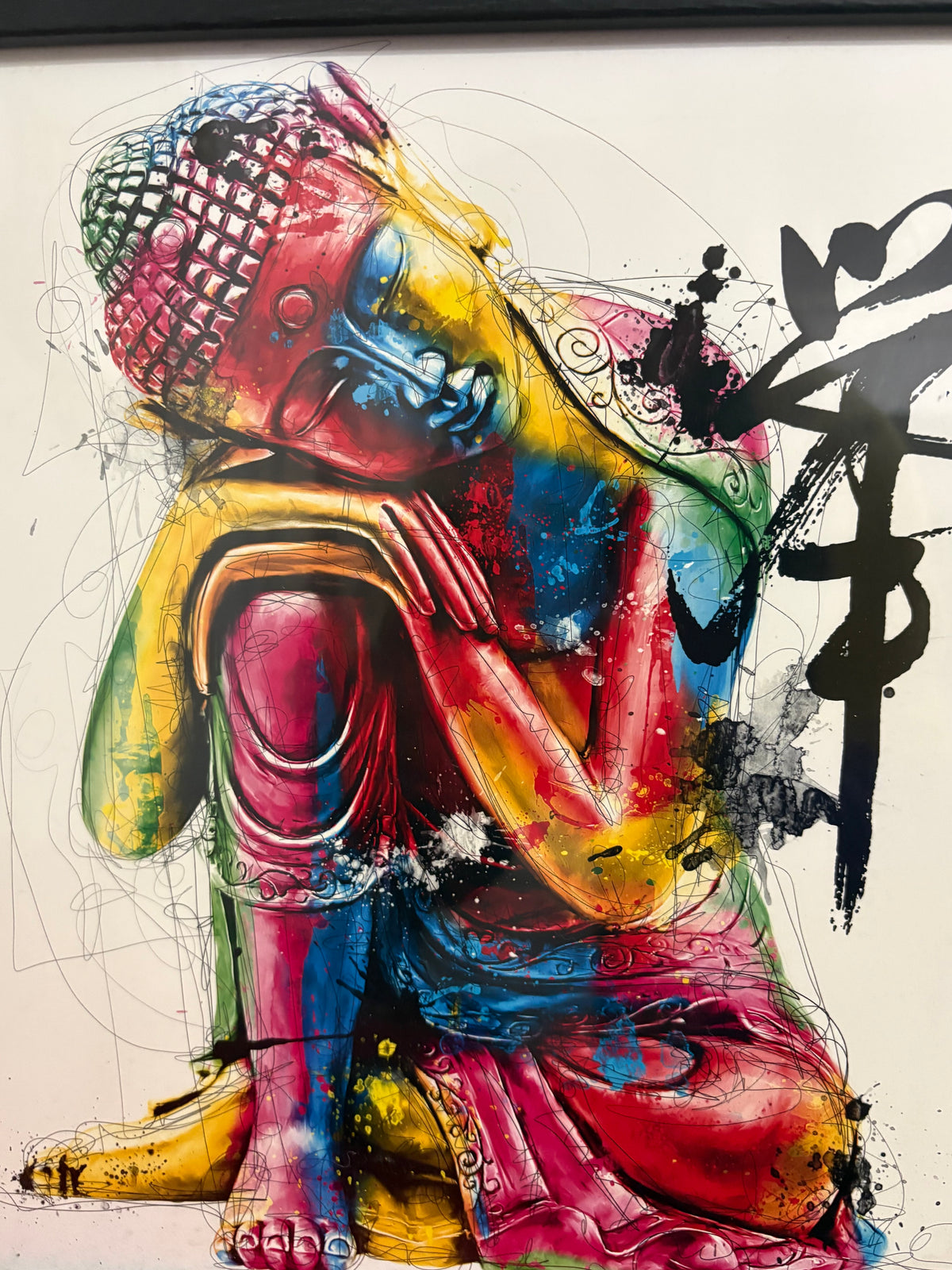 Detail of the seated Buddha print showing the multicoloured figure and black calligraphic marks.