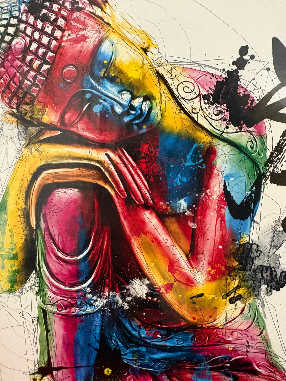 Close-up of the Buddha face and hands in vivid pink, blue and yellow.