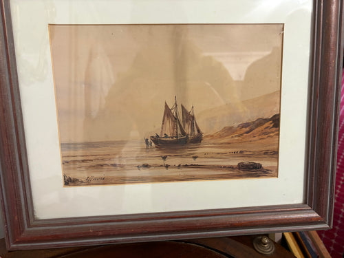 Framed maritime watercolour of beached sailing boats beside sandy dunes.
