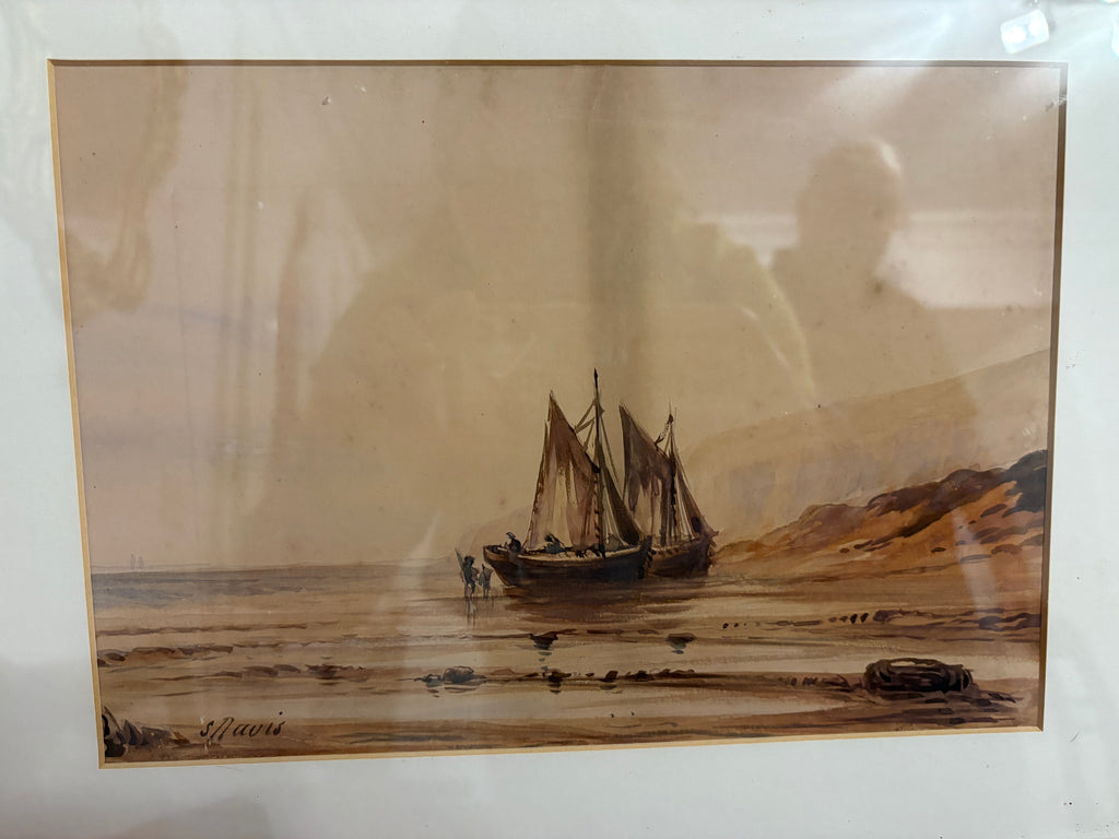 Maritime watercolour showing two sailing boats on a sandy shore within a cream mount.